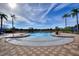 Gorgeous view of a community pool and palm trees that can be enjoyed by residents on any day at 248 Rosso Dr, Davenport, FL 33837