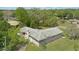 Aerial view of home with backyard and a view of a fire pit, driveway, roof and trees at 2502 Falkner Rd, Orlando, FL 32810