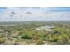 An aerial view of property showcasing the house situated among lush green landscape, trees and nearby lakes at 2502 Falkner Rd, Orlando, FL 32810