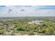 An aerial view of property showcasing the house situated among lush green landscape, trees and nearby lakes at 2502 Falkner Rd, Orlando, FL 32810