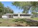 The exterior features a chimney, screened in porch, and well maintained landscaping at 2502 Falkner Rd, Orlando, FL 32810