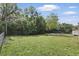 Spacious backyard with firepit, greenery, and surrounding privacy fence. Perfect for outdoor entertaining at 2502 Falkner Rd, Orlando, FL 32810