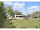 A view of the back of the home and backyard that includes a fire pit at 2502 Falkner Rd, Orlando, FL 32810