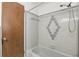 Tiled shower with a neutral color scheme, complemented by a shower head and bathtub at 2502 Falkner Rd, Orlando, FL 32810