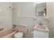 Tiled bathroom featuring a tub-shower, toilet, and sink, with a light pink color scheme at 2502 Falkner Rd, Orlando, FL 32810