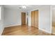 Bedroom featuring hardwood floors, ceiling fan, closet, and adjoining bathroom entrance at 2502 Falkner Rd, Orlando, FL 32810