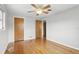 Bedroom showcasing hardwood floors, a ceiling fan, windows, closet, and doorways to other rooms at 2502 Falkner Rd, Orlando, FL 32810