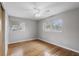 Bright bedroom with hardwood floors, ceiling fan, and two windows offering natural light at 2502 Falkner Rd, Orlando, FL 32810