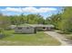 Charming single-story home featuring a well-maintained lawn, carport, and welcoming facade at 2502 Falkner Rd, Orlando, FL 32810