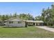 Charming home with a well manicured lawn, mature trees and an attached carport at 2502 Falkner Rd, Orlando, FL 32810