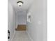 Entry hallway featuring tile flooring and an elegant light fixture with views of the living area at 2502 Falkner Rd, Orlando, FL 32810