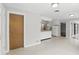 Open kitchen with white cabinetry and adjacent living area at 2502 Falkner Rd, Orlando, FL 32810