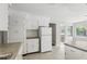 Well-lit kitchen with white cabinets, subway tile backsplash, and stainless steel appliances at 2502 Falkner Rd, Orlando, FL 32810