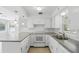 Bright kitchen featuring white cabinets, modern appliances, subway tile backsplash, and plenty of counter space at 2502 Falkner Rd, Orlando, FL 32810