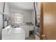 Functional laundry room with a washing machine, dryer, utility sink, and storage shelves at 2502 Falkner Rd, Orlando, FL 32810