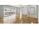 Inviting living room with gleaming hardwood floors and sliding glass doors to the outdoor lanai at 2502 Falkner Rd, Orlando, FL 32810