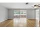 Open living room with hardwood floors and access to an enclosed lanai at 2502 Falkner Rd, Orlando, FL 32810