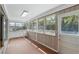 Enclosed sunroom with tile floors, many windows and natural light at 2502 Falkner Rd, Orlando, FL 32810