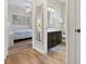 Bathroom with dark cabinets and a view into the bedroom with decorative artwork on the wall at 2774 Almaton Loop # 403, Kissimmee, FL 34747