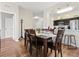 Open concept dining area flowing into kitchen with breakfast bar, seating for six, and wood-style floors at 2774 Almaton Loop # 403, Kissimmee, FL 34747