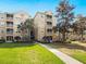 Inviting multi-story condo building with well-manicured landscaping and a sidewalk leading to the entrance at 2774 Almaton Loop # 403, Kissimmee, FL 34747