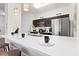 Stylish kitchen bar with modern stools, quartz countertops, and stainless steel appliances at 2774 Almaton Loop # 403, Kissimmee, FL 34747