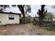 View of the backyard showing a mix of grass, landscaping and wooden fence at 3440 S Nashville Ave, Orlando, FL 32839