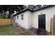 Backyard features a wooden fence, efficient AC unit, and door access to the home's interior at 3440 S Nashville Ave, Orlando, FL 32839