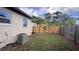 Expansive backyard showcasing a well-maintained fence, lush greenery, and an efficient AC unit at 3440 S Nashville Ave, Orlando, FL 32839