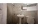 The renovated bathroom has tile walls and modern fixtures at 3440 S Nashville Ave, Orlando, FL 32839