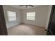 This cozy bedroom has tiled floors, a ceiling fan, and bright windows at 3440 S Nashville Ave, Orlando, FL 32839