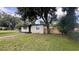 A single-story home with a well-kept lawn and mature trees in the front yard at 3440 S Nashville Ave, Orlando, FL 32839