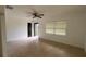 A bright living room with tile floors, a ceiling fan, and a front-facing window at 3440 S Nashville Ave, Orlando, FL 32839
