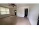 A bright living room boasts a ceiling fan and tile flooring, offering a clean, modern aesthetic at 3440 S Nashville Ave, Orlando, FL 32839