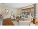 Well-lit living room with hardwood floors, neutral decor, and a view into a bedroom, offering a comfortable living space at 3803 Bobolink Ln, Orlando, FL 32803