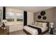 Comfortable bedroom featuring large windows, a cozy bed, and stylish decor at 386 Wayland Dr, Haines City, FL 33844