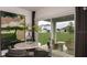 Bright dining area features modern art, stylish furniture, and sliding doors to the outdoor patio with backyard views at 386 Wayland Dr, Haines City, FL 33844
