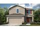 Charming two-story home with neutral siding, a two-car garage, and simple landscaping at 386 Wayland Dr, Haines City, FL 33844