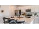 Modern kitchen features white cabinets, stainless steel appliances, and a spacious island with seating at 386 Wayland Dr, Haines City, FL 33844