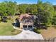 Aerial view displays the property's spacious driveway, charming home architecture, and well-maintained landscaping at 40600 Louise Rd, Umatilla, FL 32784