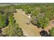 An aerial shot of the property featuring a long, winding driveway through lush, mature trees and landscaping at 40600 Louise Rd, Umatilla, FL 32784
