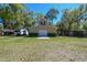 Barn with neutral siding, double doors, and green grass at 40600 Louise Rd, Umatilla, FL 32784