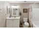 A well-lit bathroom featuring a white vanity, tiled floors, and a shower/tub combo at 40600 Louise Rd, Umatilla, FL 32784