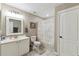 A well-lit bathroom featuring a white vanity, tiled floors, and a shower/tub combo at 40600 Louise Rd, Umatilla, FL 32784