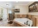 Elegant bathroom featuring a soaking tub, glass shower, and neutral tile flooring at 40600 Louise Rd, Umatilla, FL 32784