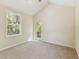 Bright and airy bedroom with a neutral palette and a door with glass, offering outdoor views at 40600 Louise Rd, Umatilla, FL 32784