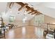 Expansive bonus room featuring wood floors, exposed beams, and abundant natural light at 40600 Louise Rd, Umatilla, FL 32784