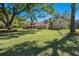 Charming single-Gathering home featuring a spacious lawn, mature trees, and lovely landscaping at 40600 Louise Rd, Umatilla, FL 32784