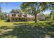 Charming single-Gathering home with a spacious lawn, mature trees, and landscaping at 40600 Louise Rd, Umatilla, FL 32784