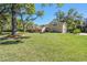 Charming single-Gathering home featuring a spacious lawn, mature trees, and lovely landscaping at 40600 Louise Rd, Umatilla, FL 32784